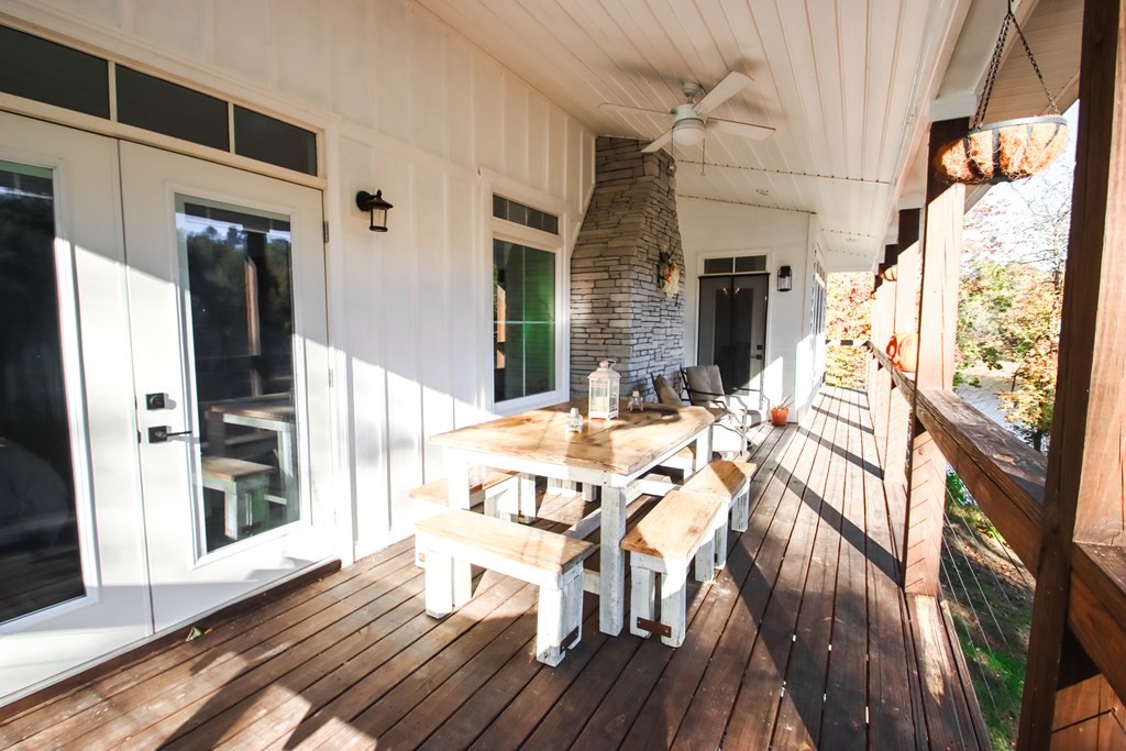 608 Lakeview Road Walling, TN 38587 - Photo 25 of 68 a view of a patio with table and chairs and wooden floor