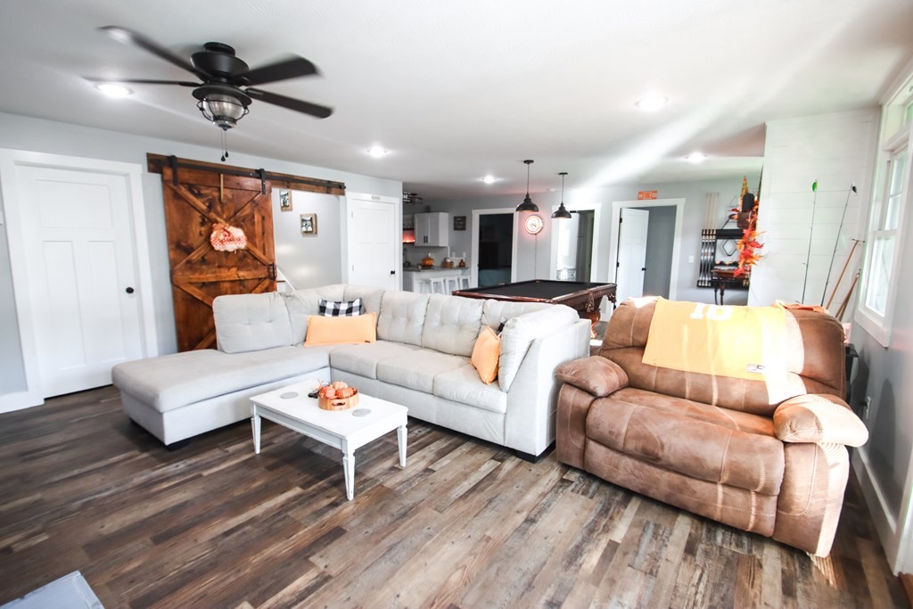 608 Lakeview Road Walling, TN 38587 - Photo 37 of 68 a living room with furniture ceiling fan and a wooden floor