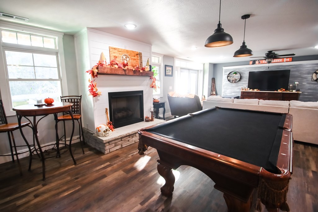 608 Lakeview Road Walling, TN 38587 - Photo 39 of 68 a living room with furniture a fireplace and a flat screen tv