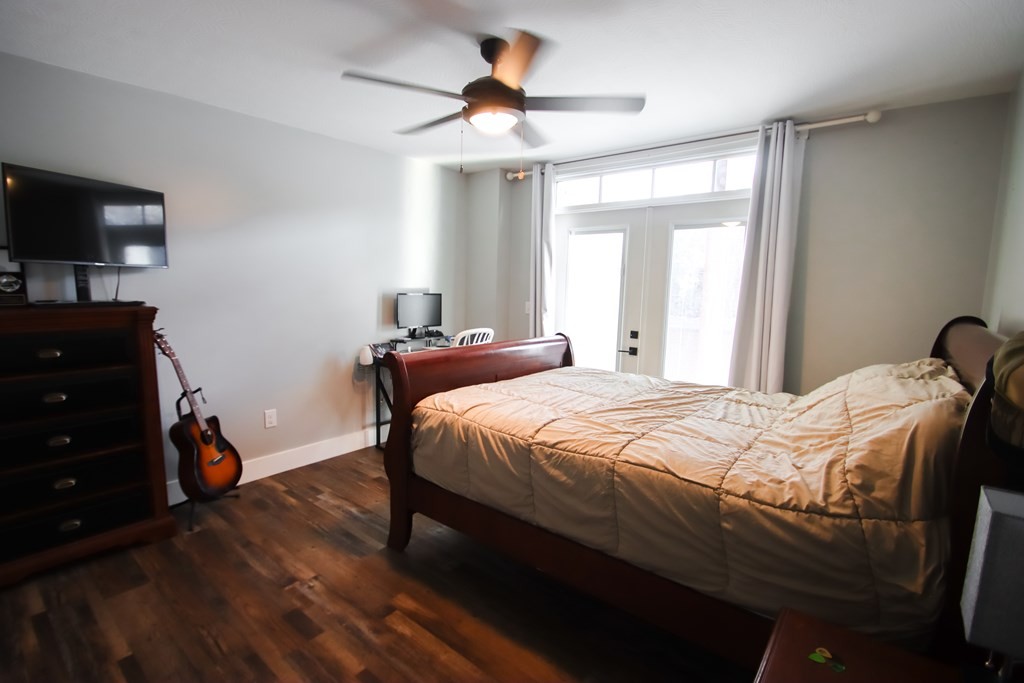 608 Lakeview Road Walling, TN 38587 - Photo 40 of 68 a bedroom with a bed and a flat tv screen on the dresser