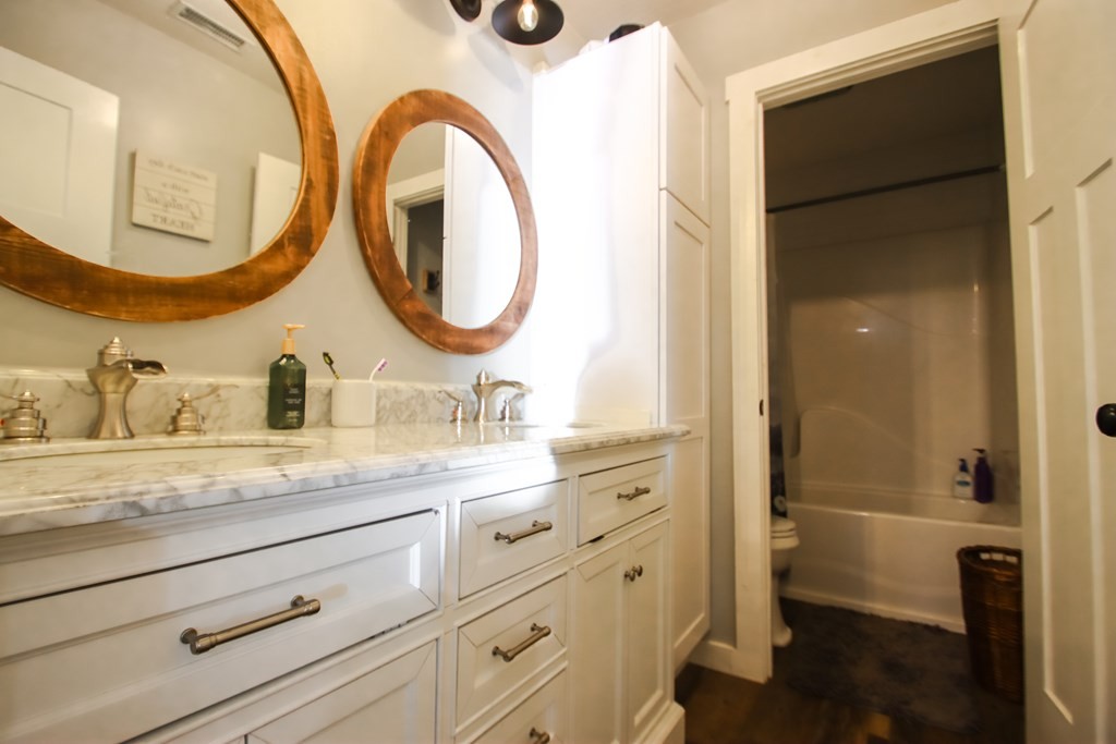 608 Lakeview Road Walling, TN 38587 - Photo 41 of 68 a bathroom with a granite countertop sink and a mirror