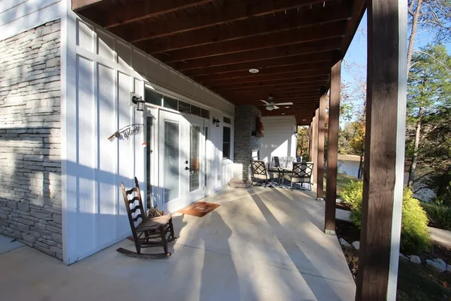 a view of a balcony with wooden floor and lake view