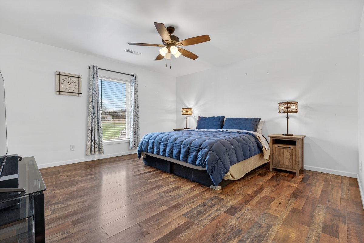 15419 Old Palestine Road Crofton, KY 42217 - Photo 26 of 53 a bedroom with a large bed and a ceiling fan