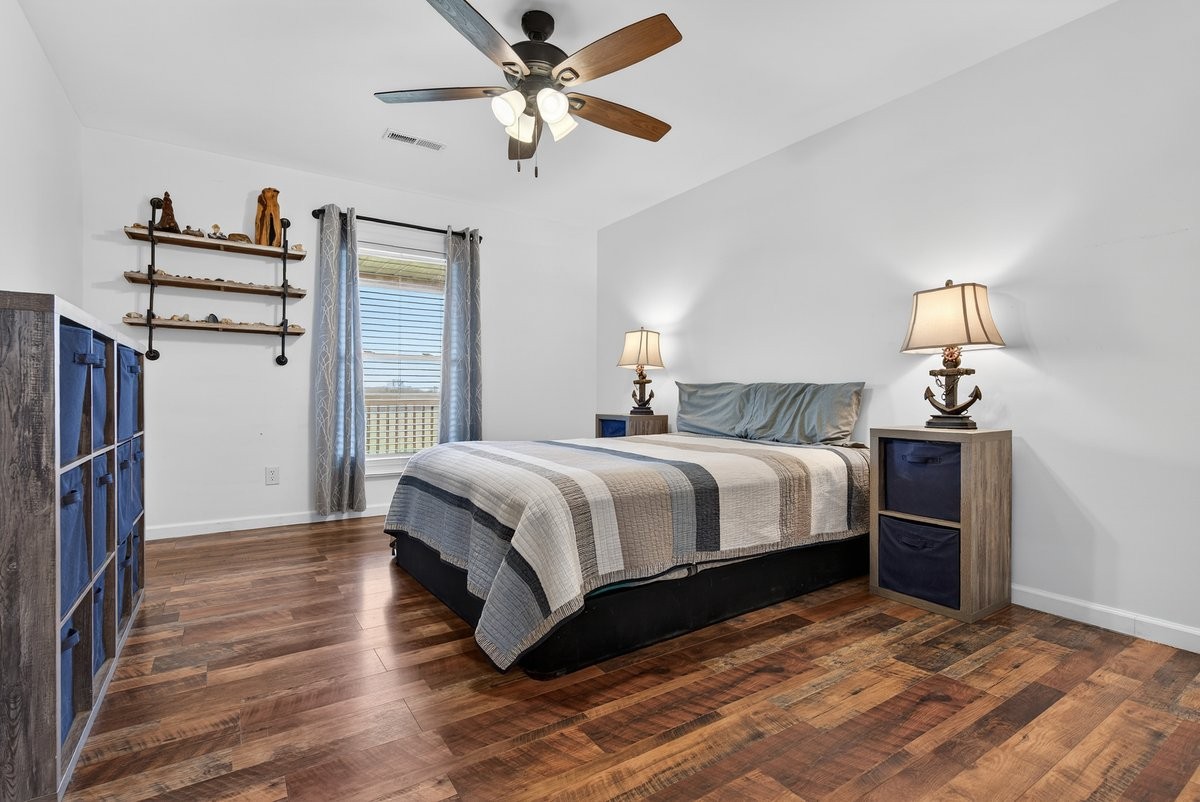 15419 Old Palestine Road Crofton, KY 42217 - Photo 35 of 53 a bedroom with a bed and a chandelier