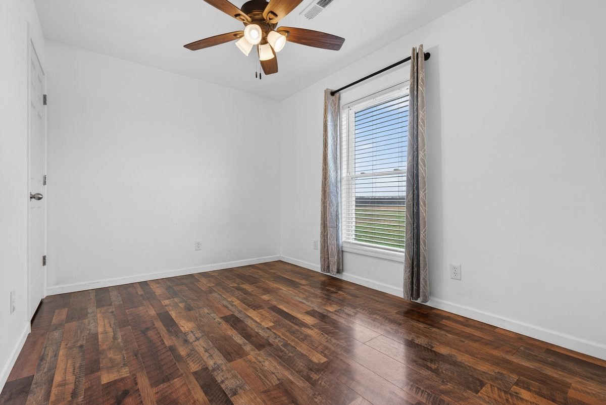 15419 Old Palestine Road Crofton, KY 42217 - Photo 38 of 53 an empty room with wooden floor fan and windows