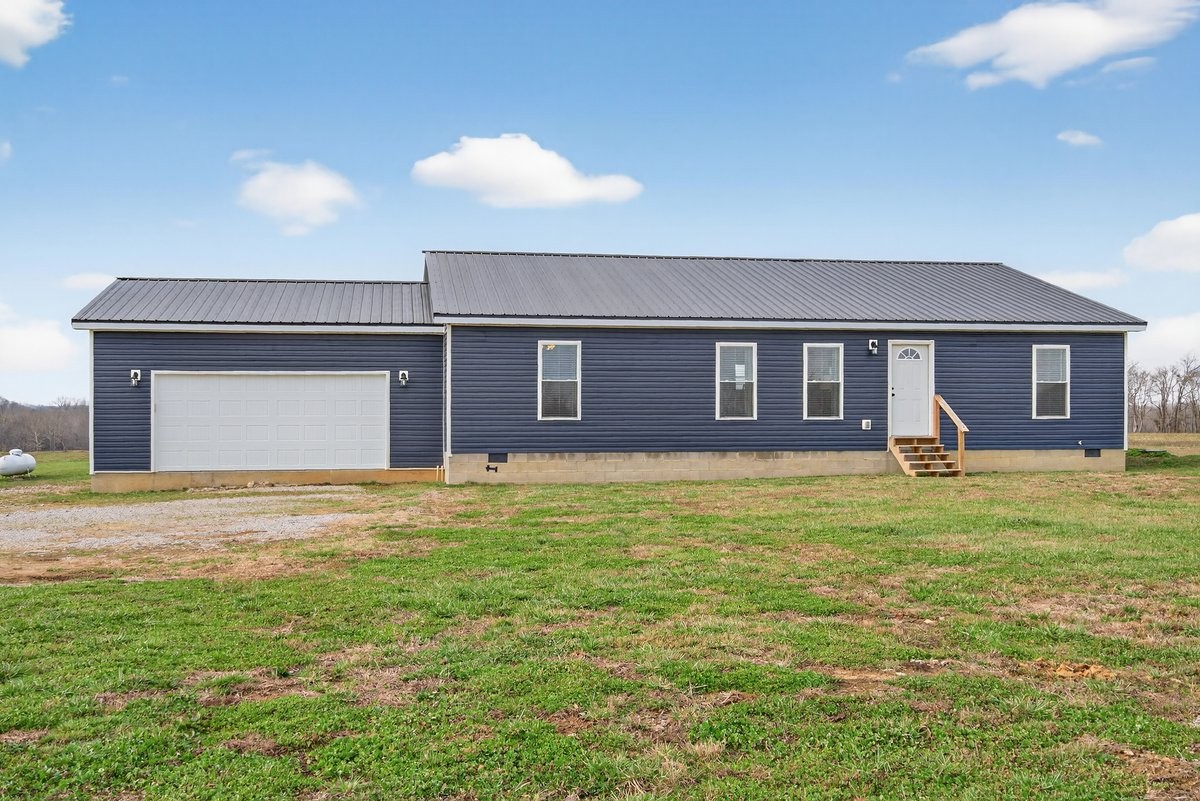 15419 Old Palestine Road Crofton, KY 42217 - Photo 4 of 53 a front view of a house with a garden