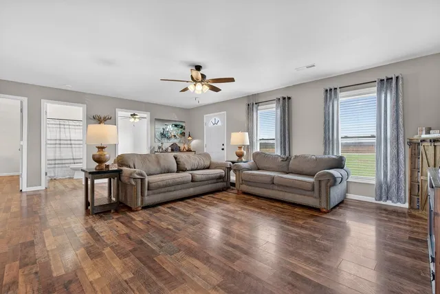 a living room with furniture and a flat screen tv