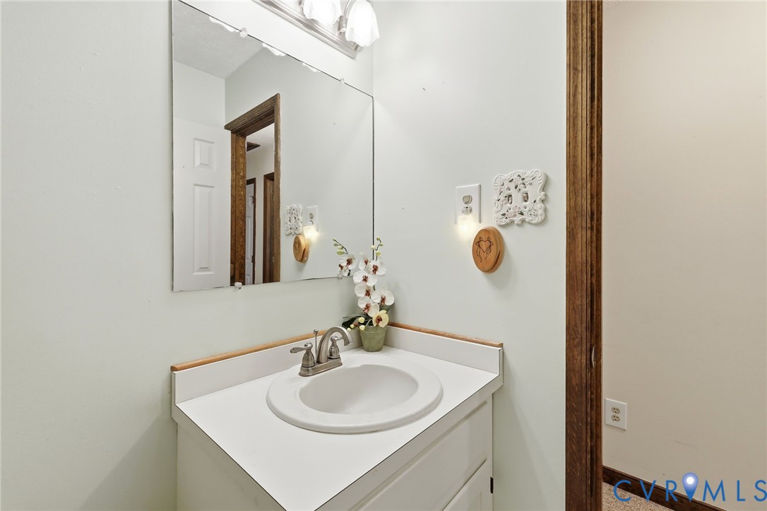 10111 Tunstall Road New Kent, VA 23124 - Photo 25 of 52 White vanity with an integrated sink, brushed nick