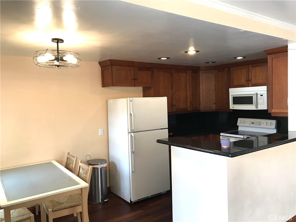 3103 Evening Way, Unit B La Jolla, CA 92037 - Photo 3 of 10 a kitchen with a refrigerator a stove top oven a sink and dishwasher