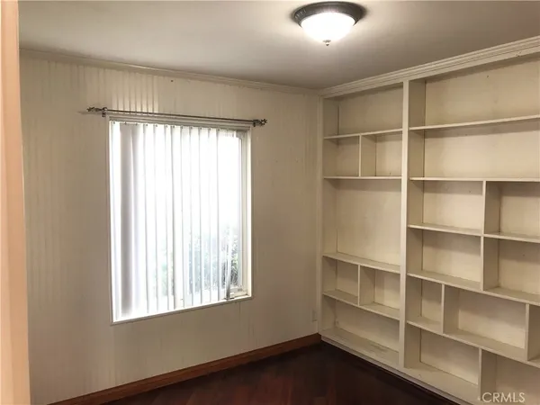 a view of a room with windows and cabinet