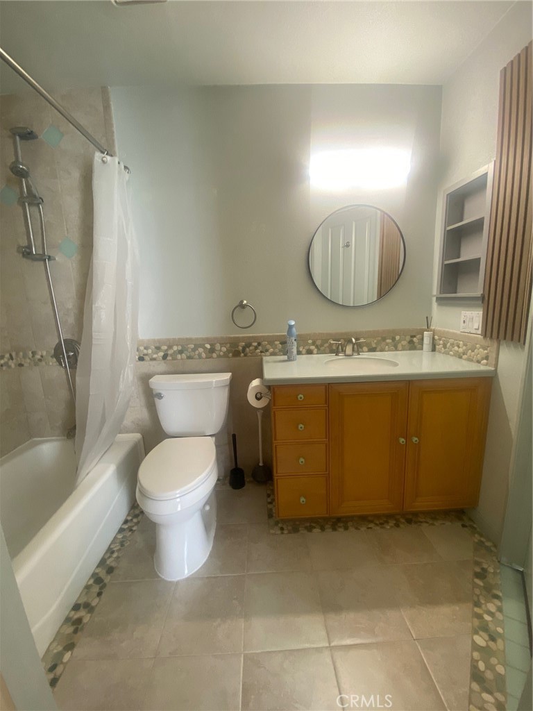 3103 Evening Way, Unit B La Jolla, CA 92037 - Photo 8 of 10 a bathroom with a granite countertop toilet a sink and bathtub