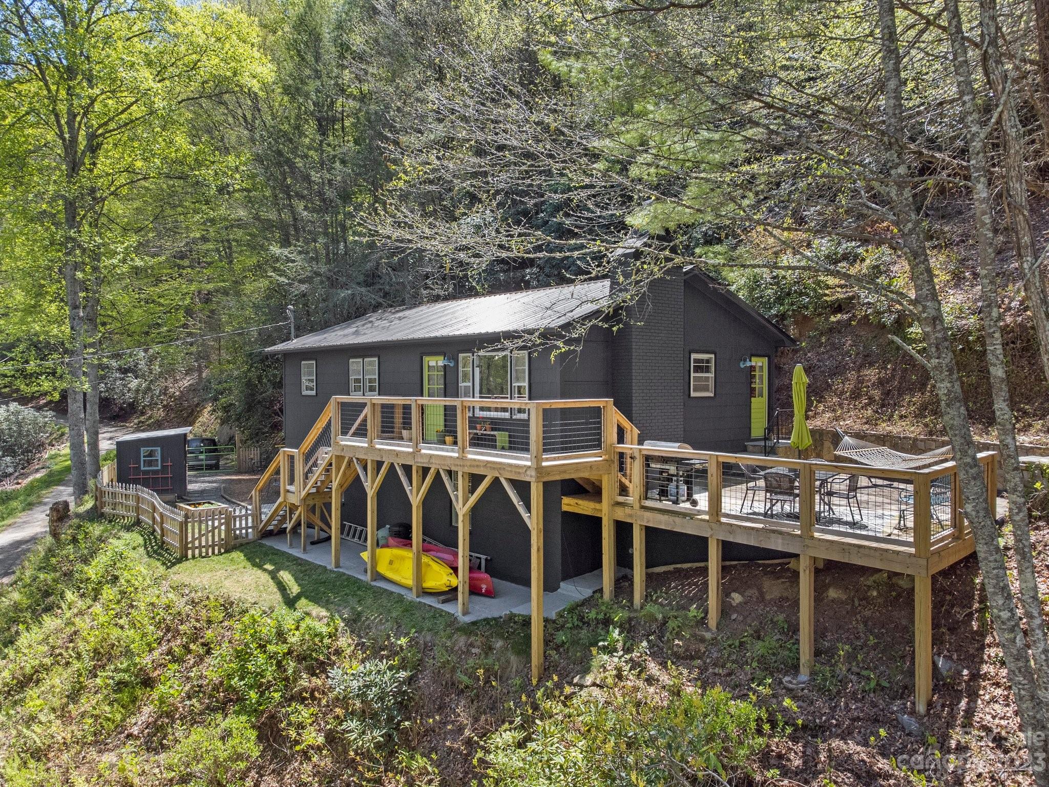 an aerial view of a house with swimming pool and sitting area