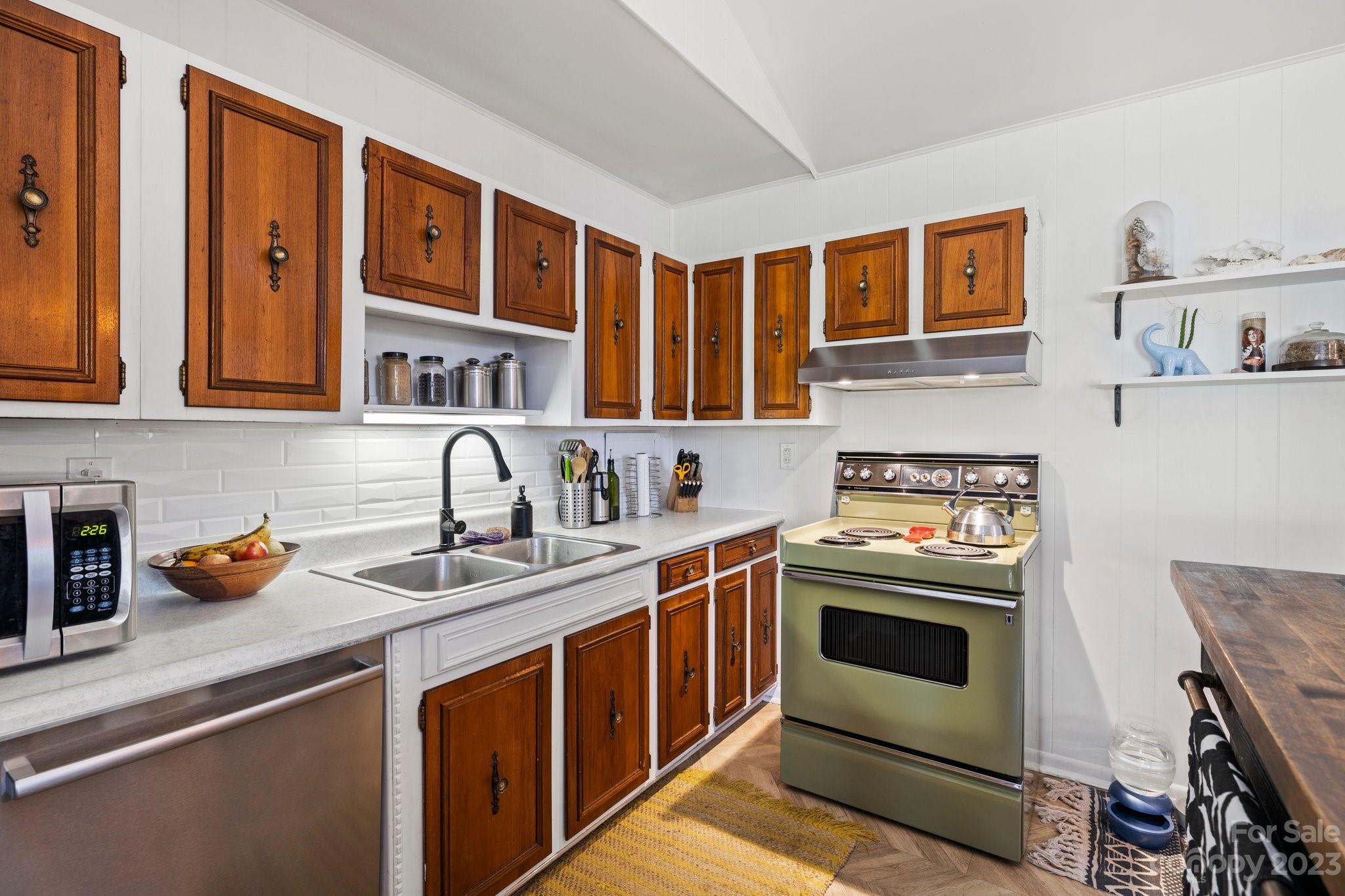 316 Rules Run Road Clyde, NC 28721 - Photo 18 of 47 a kitchen with stainless steel appliances granite countertop a stove and a sink