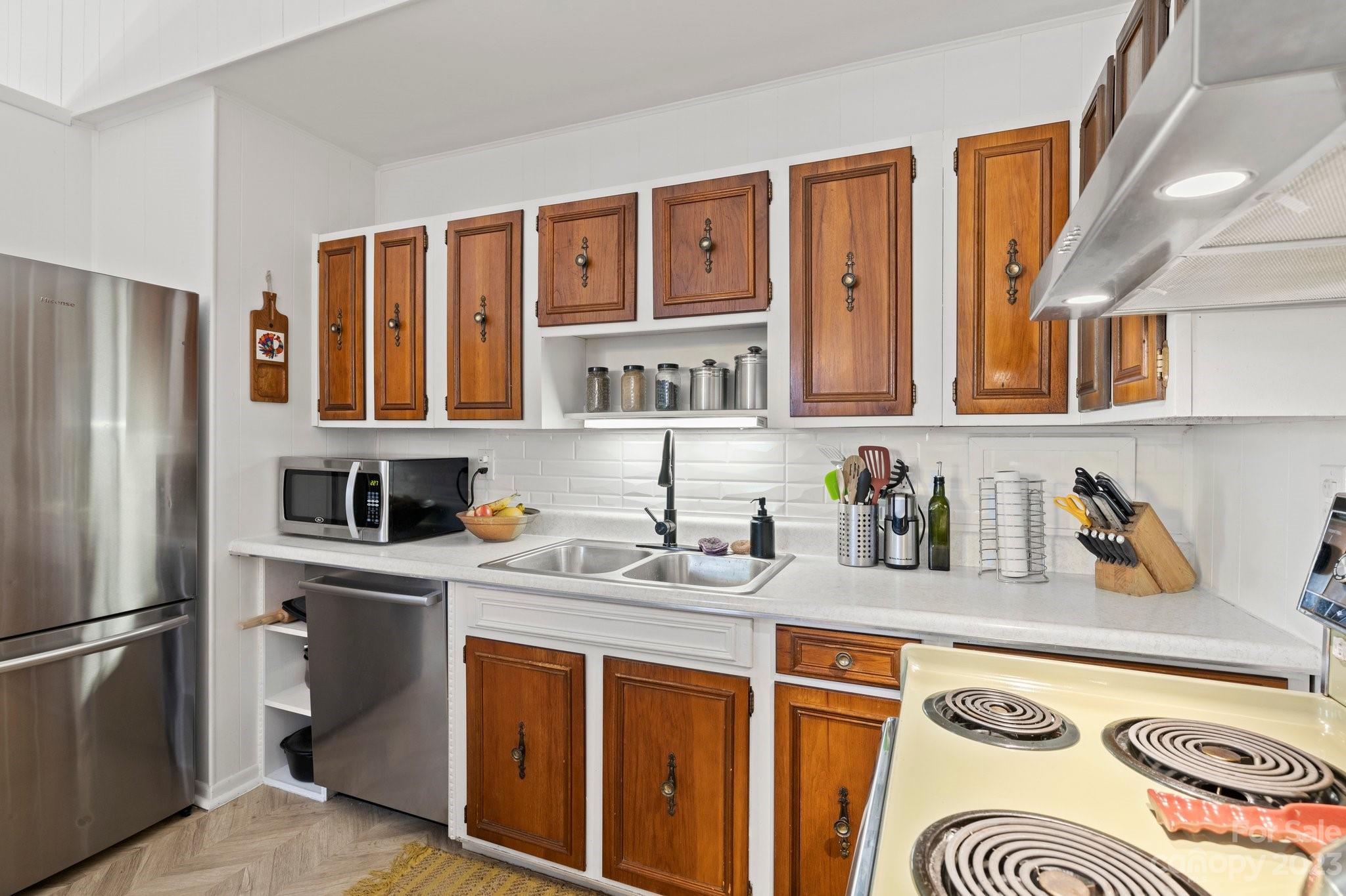 316 Rules Run Road Clyde, NC 28721 - Photo 19 of 47 a kitchen with stainless steel appliances granite countertop a refrigerator and a stove top oven