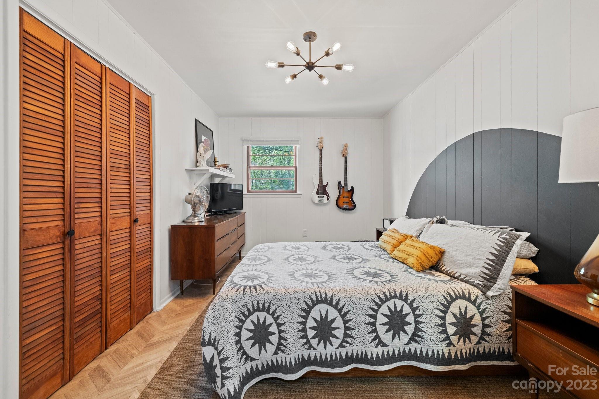 316 Rules Run Road Clyde, NC 28721 - Photo 22 of 47 a bedroom with a bed and a chandelier