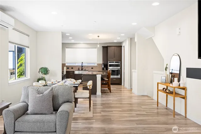 a living room with furniture and view kitchen
