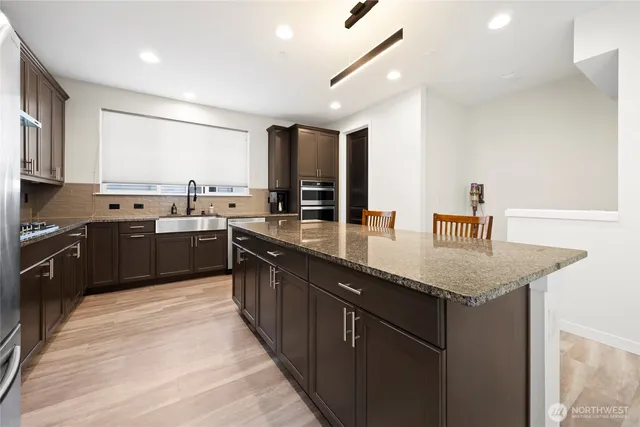 a kitchen with stainless steel appliances granite countertop counter space a sink and cabinets