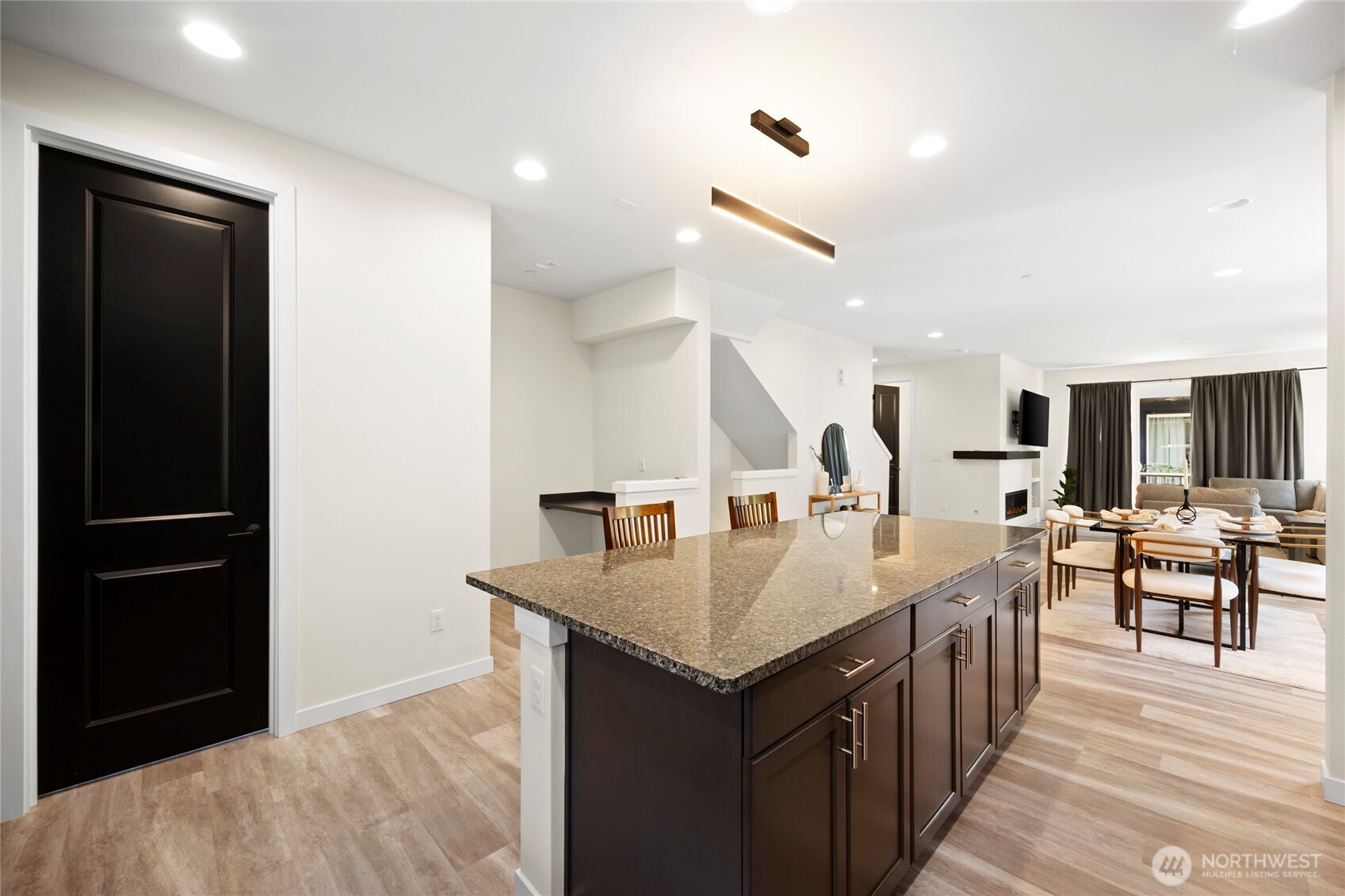 508 237th Street Southeast, Unit E Bothell, WA 98021 - Photo 18 of 35 a room with a table chairs and a refrigerator