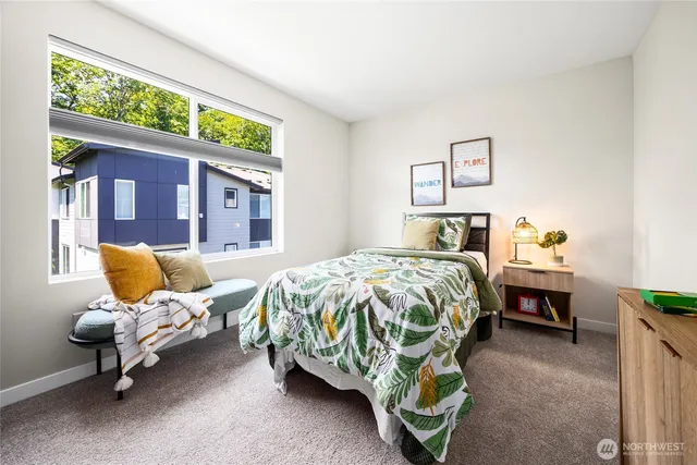 a bedroom with a bed and chair