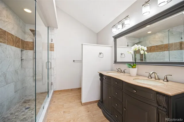 a spacious bathroom with a granite countertop sink mirror and shower