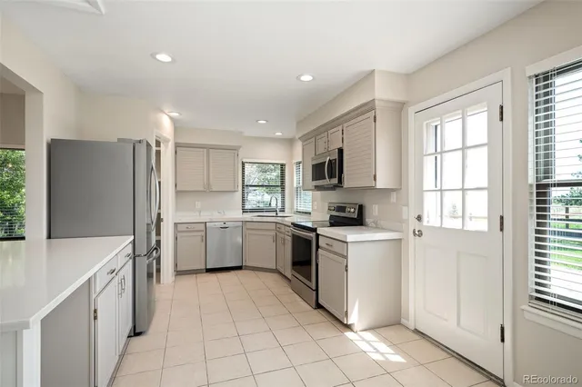 a kitchen with a stove a sink and a refrigerator