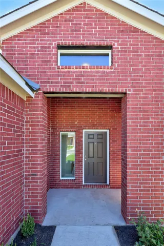 a front view of a building with potted plants