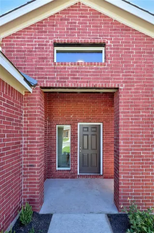 a front view of a building with potted plants
