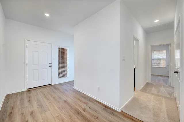 wooden floor in a hall with an empty room