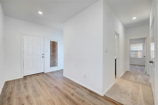 wooden floor in a hall with an empty room