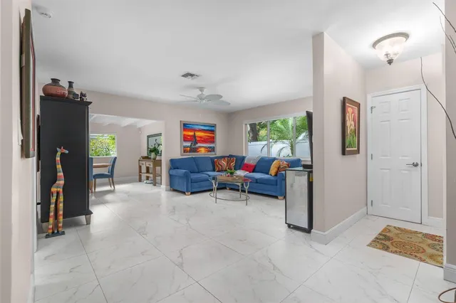 a kitchen with granite countertop white cabinets and stainless steel appliances