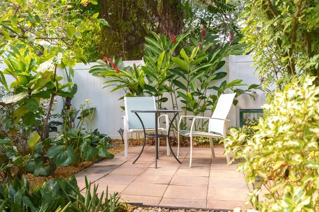 a backyard of a house with outdoor seating