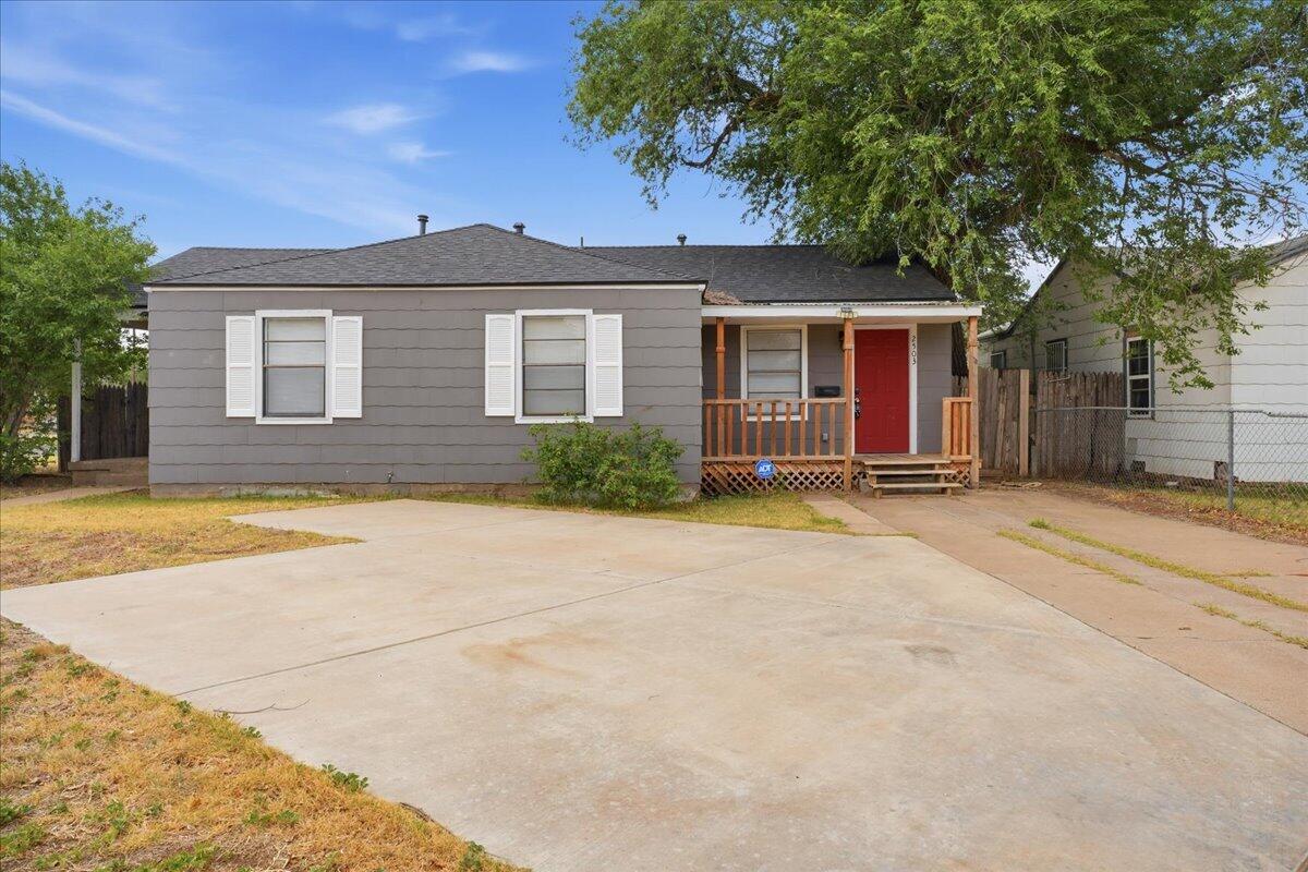 2503 30th Street Lubbock, TX 79410 - Photo 1 of 26 a view of a house with a swimming pool and a large tree