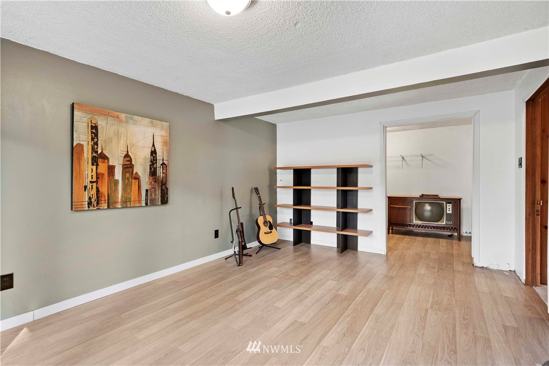 23718 23rd Avenue West Bothell, WA 98021 - Photo 23 of 36 a view of empty room with wooden floor and chair