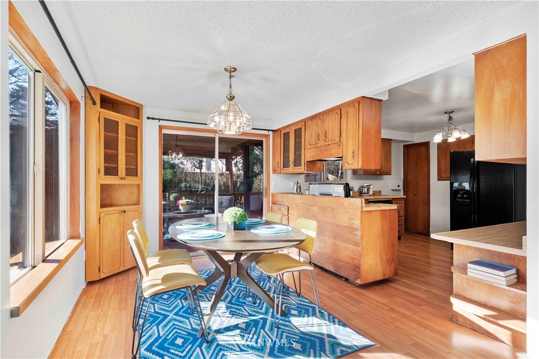 23718 23rd Avenue West Bothell, WA 98021 - Photo 8 of 36 a dining room with wooden floor and chandelier