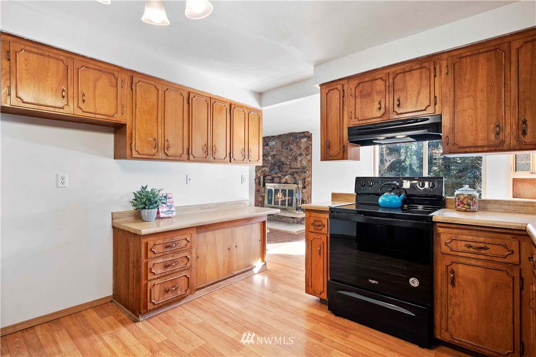 23718 23rd Avenue West Bothell, WA 98021 - Photo 10 of 36 a kitchen with stainless steel appliances granite countertop a stove top oven a sink dishwasher and cabinets with wooden floor