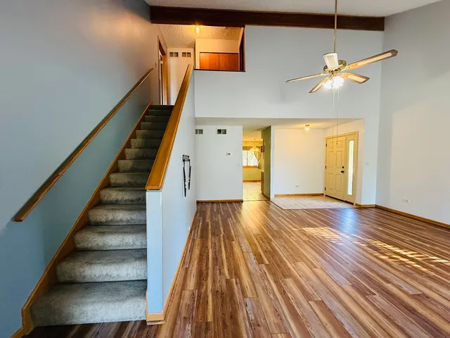 a view of entryway and hall with wooden floor