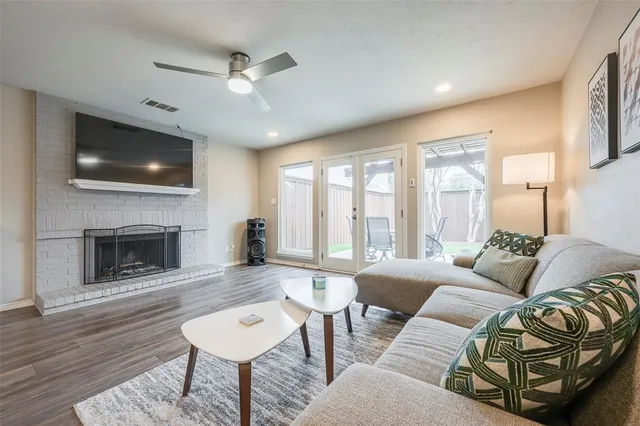 a living room with furniture a fireplace and a flat screen tv