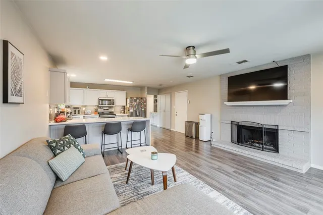a living room with furniture a fireplace and a flat screen tv