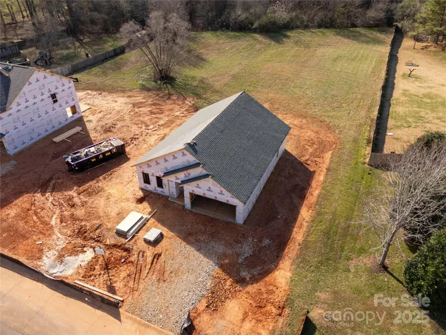 a view of a house with swimming pool and sitting area