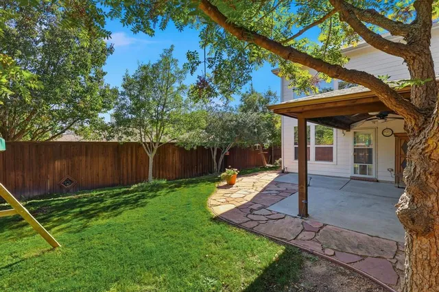 a backyard of a house with table and chairs