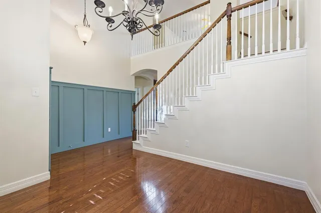 a view of staircase with wooden floor and fan
