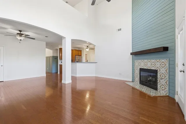 a view of a livingroom with wooden floor and a fireplace