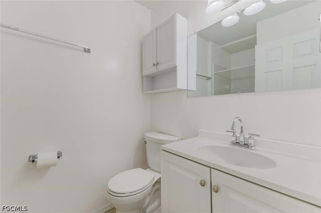 16595 Davis Road Fort Myers, FL 33908 - Photo 21 of 31 a bathroom with a sink toilet and vanity