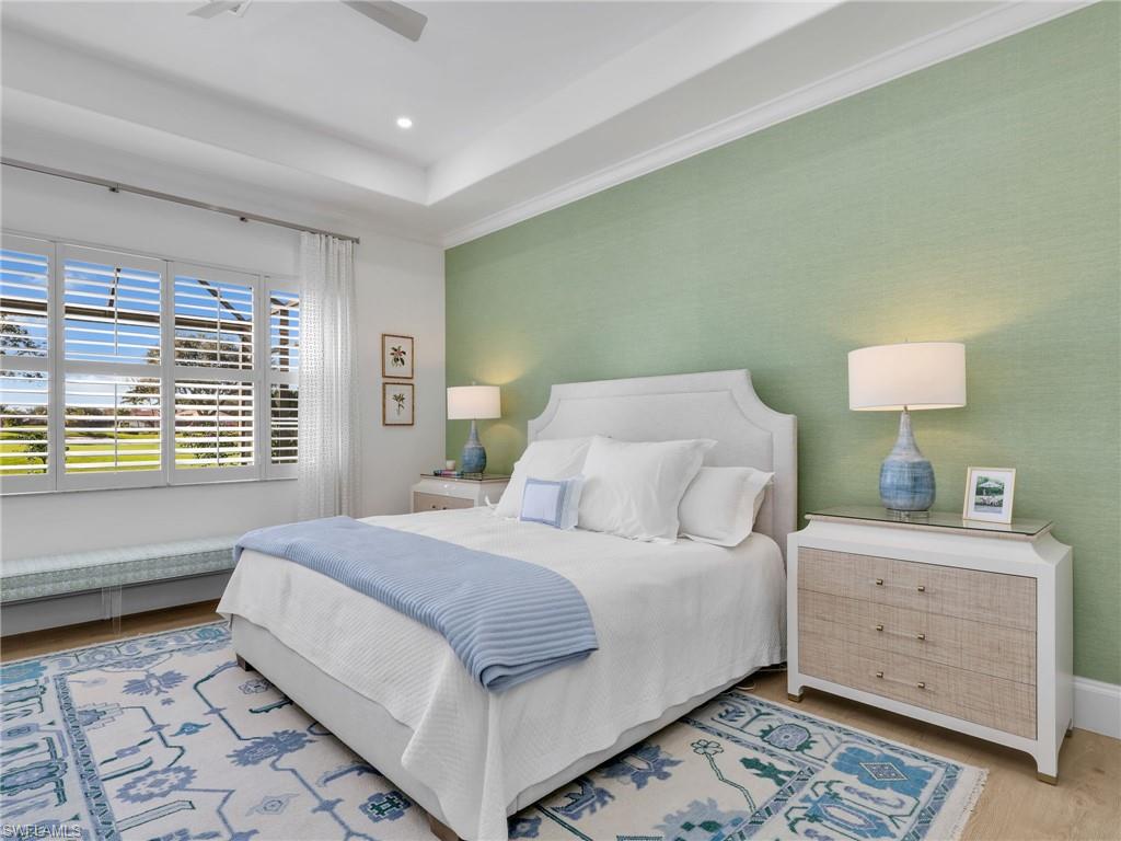 4304 Kensington High Street Naples, FL 34105 - Photo 18 of 40 a bedroom with a bed and a night stand