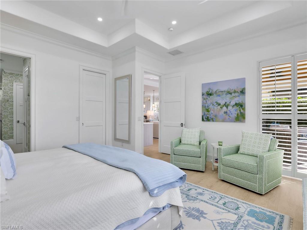 4304 Kensington High Street Naples, FL 34105 - Photo 20 of 40 a bedroom with a bed and a couch