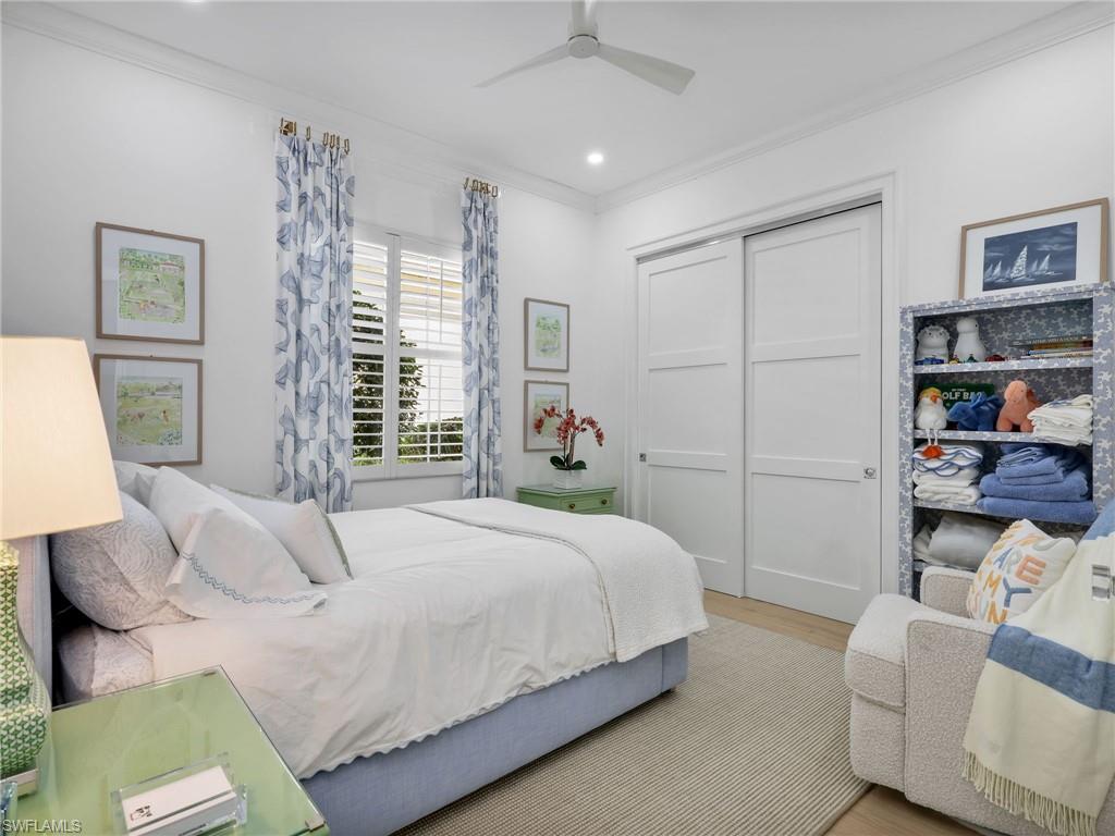 4304 Kensington High Street Naples, FL 34105 - Photo 23 of 40 a bedroom with a bed and a couch