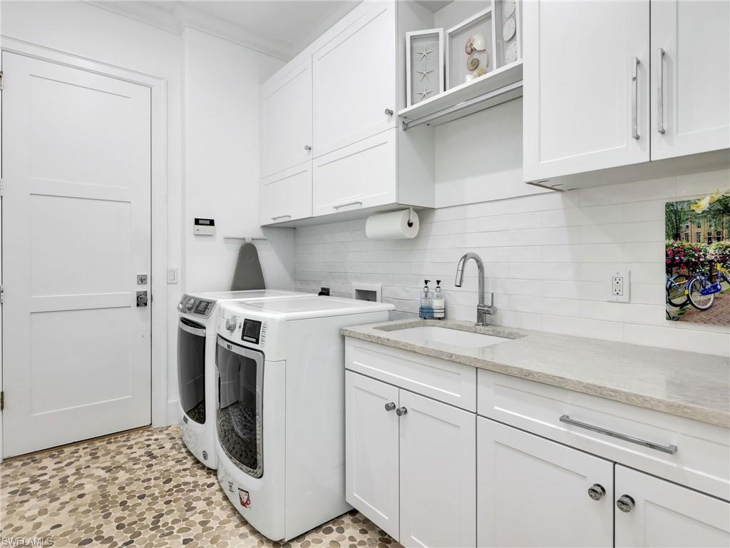 4304 Kensington High Street Naples, FL 34105 - Photo 26 of 40 a kitchen with a sink and cabinets