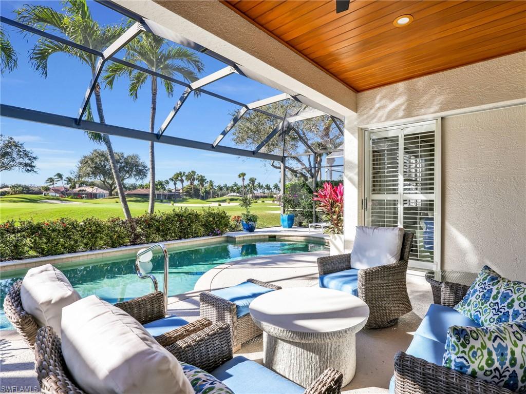 4304 Kensington High Street Naples, FL 34105 - Photo 28 of 40 a view of a patio with couches chairs and a yard
