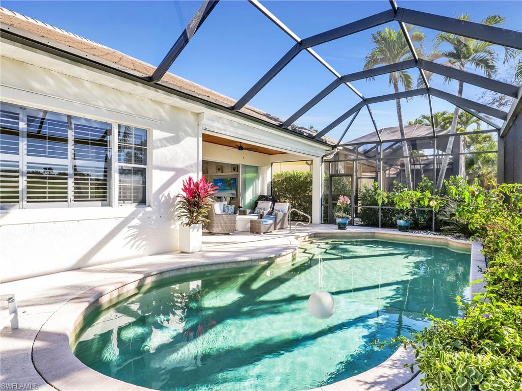 4304 Kensington High Street Naples, FL 34105 - Photo 30 of 40 a view of a house with backyard porch and sitting area
