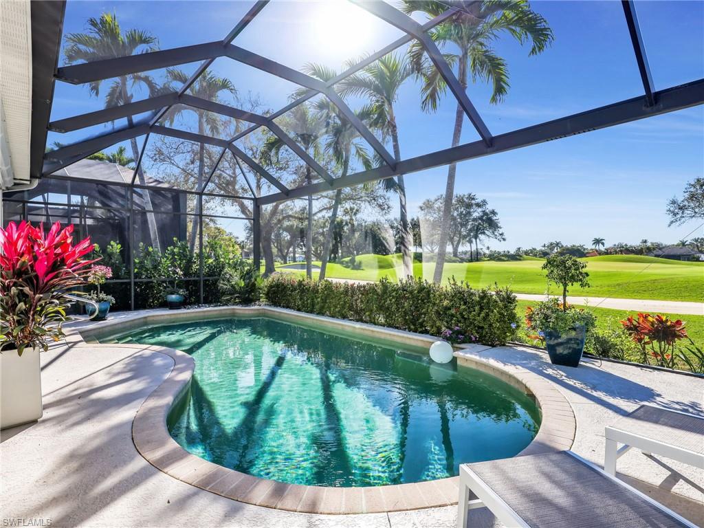 4304 Kensington High Street Naples, FL 34105 - Photo 31 of 40 a view of a swimming pool with a couches in a patio